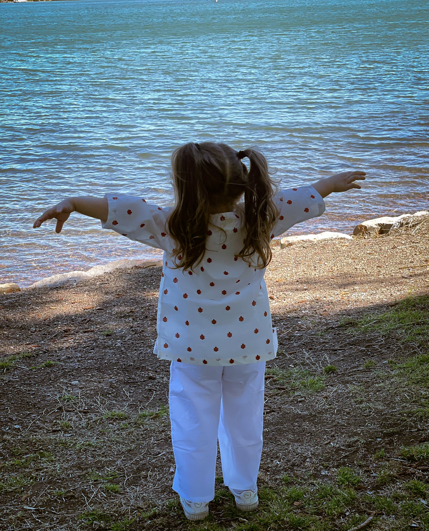 Unisex KIds cotton set featuring an adorable ladybug print, including a long top and white cotton pants for all-day comfort.