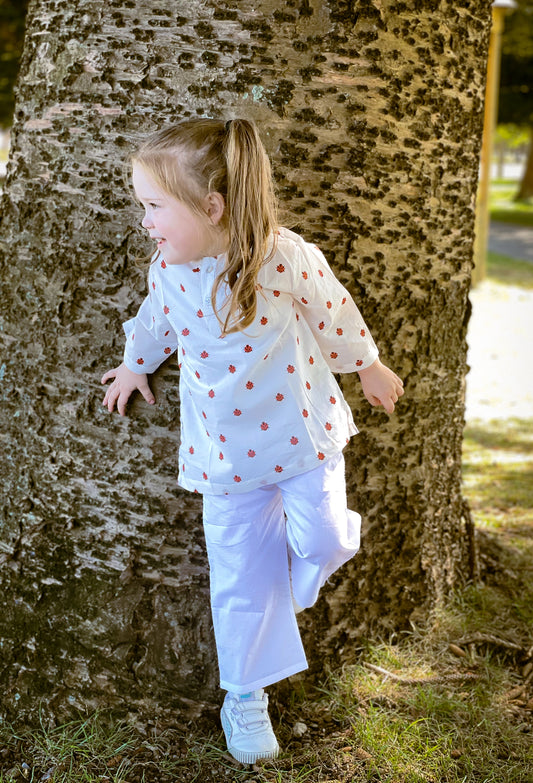 Unisex KIds cotton set featuring an adorable ladybug print, including a long top and white cotton pants for all-day comfort.